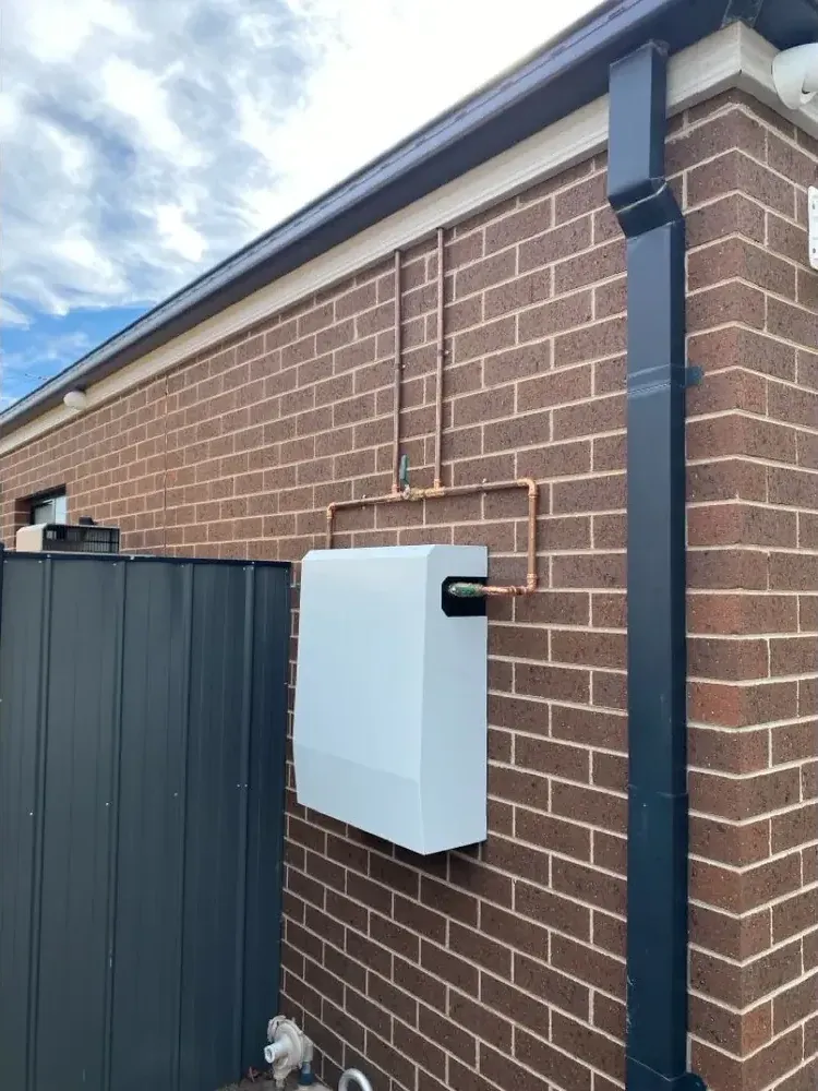 Whole-home water filtration on white brick