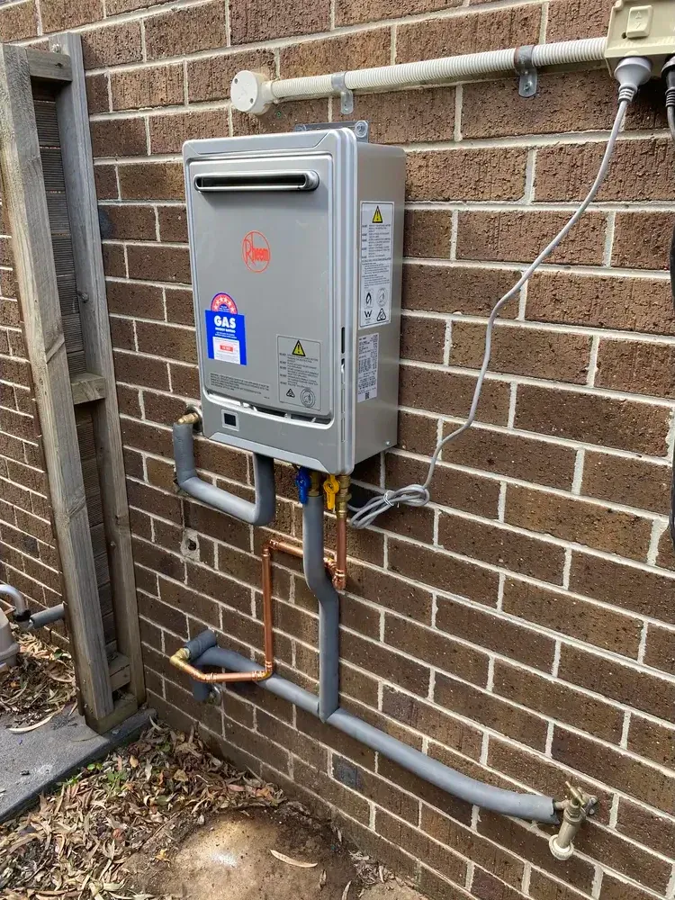 Continuous flow hot water system on a brick wall